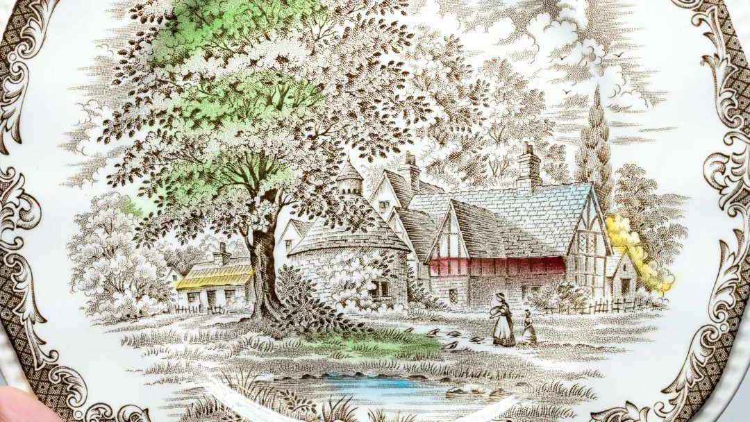 A transfer on a plate, with hand-decorated elements.